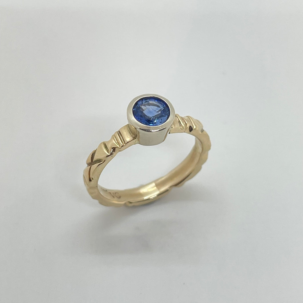 Truly unique cornflower blue sapphire ring on hand carved yellow gold band